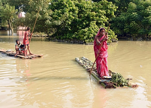 People Use Raft To Move IN Flooded Rural Assam